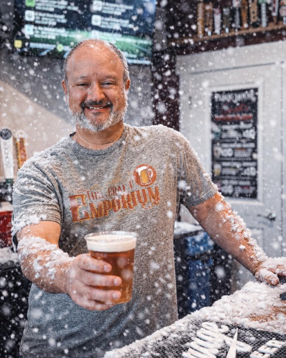 Owner holding a craft beer at The Craft Emporium in Bellefontaine Ohio